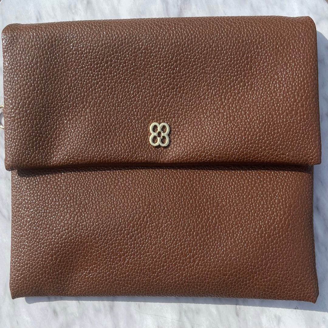 brown clutch and can be held as a  Wristlet